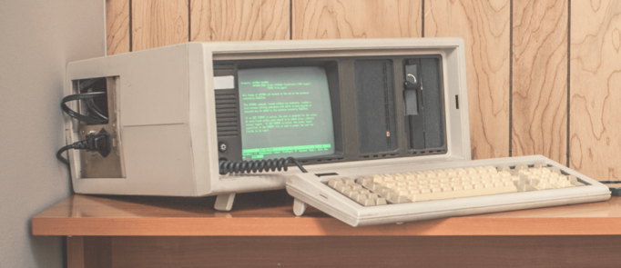 A really ancient computer. The screen has green text and is about 4 inches across.